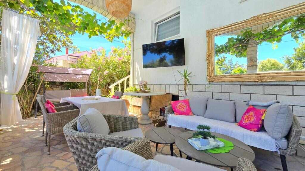 Shaded terrace with seating at Art Villa Ines